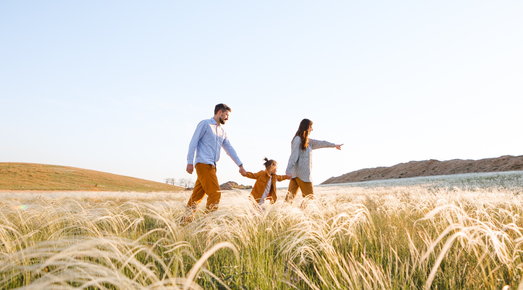 a family walking through a wheat field