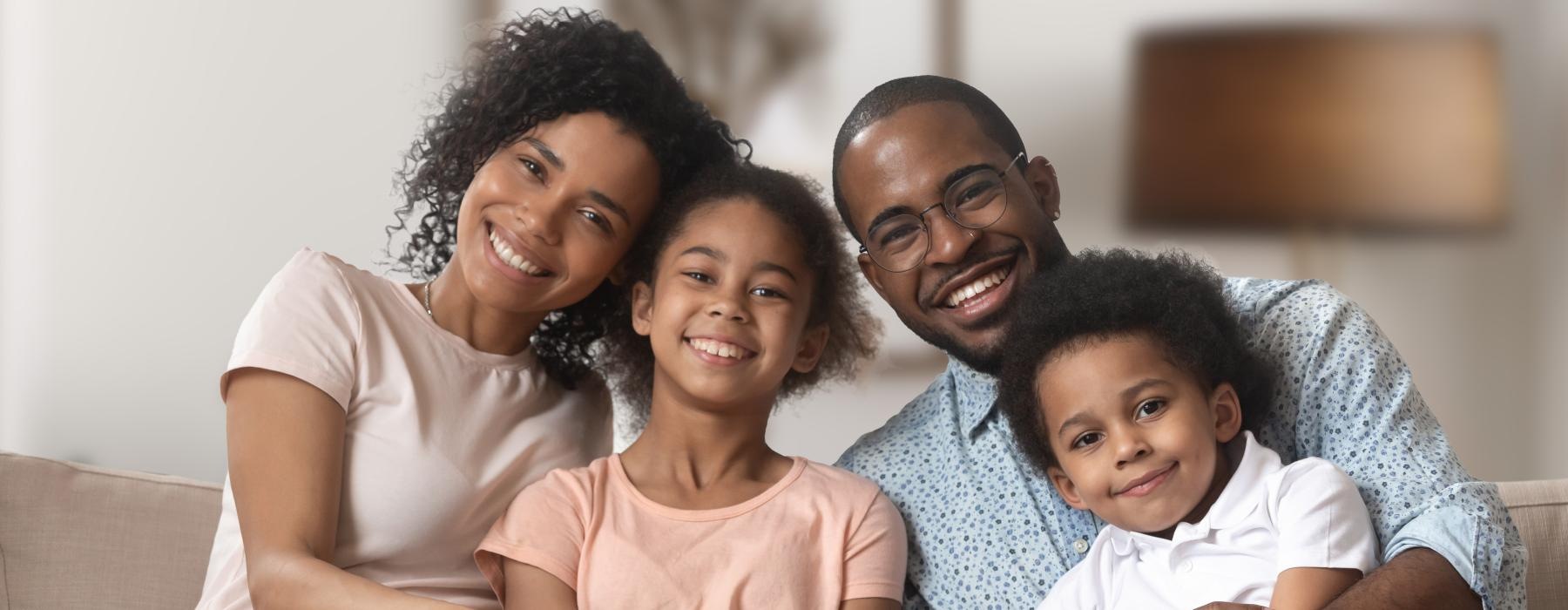 a family sitting on a couch