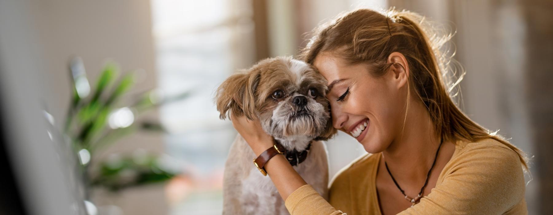 a woman holding a dog