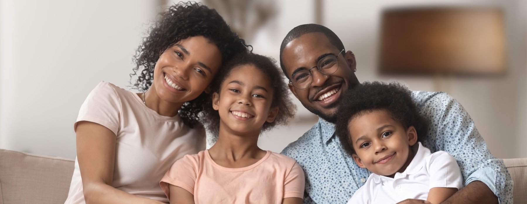 a family sitting on a couch