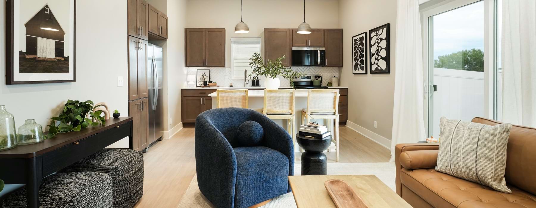 a living room with a couch and kitchen view